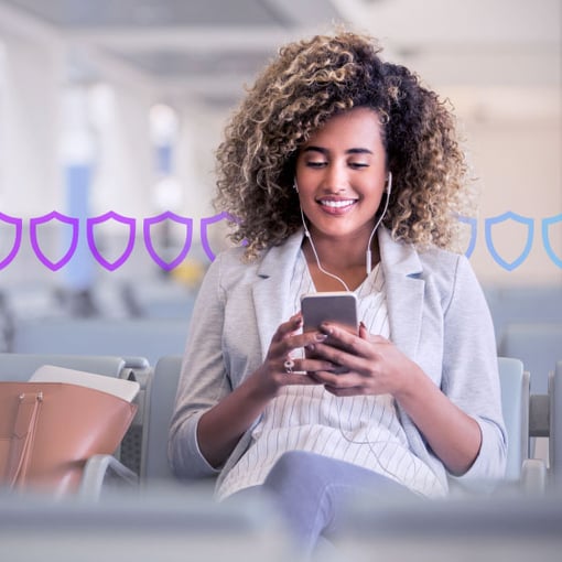Photo illustration of a woman with a cell phone in her hands and wearing headphones; behind her are a row of security badges in purple and blue superimposed onto the background of the photo indicating security measures